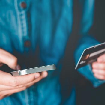 Hand holding smart phone and credit card